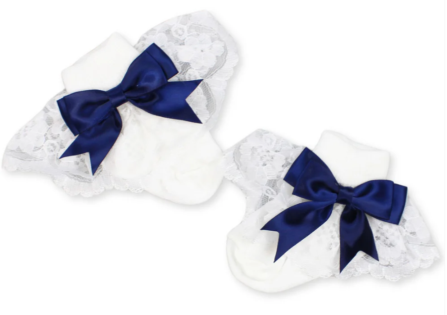 White baby socks with navy blue bows on a white background