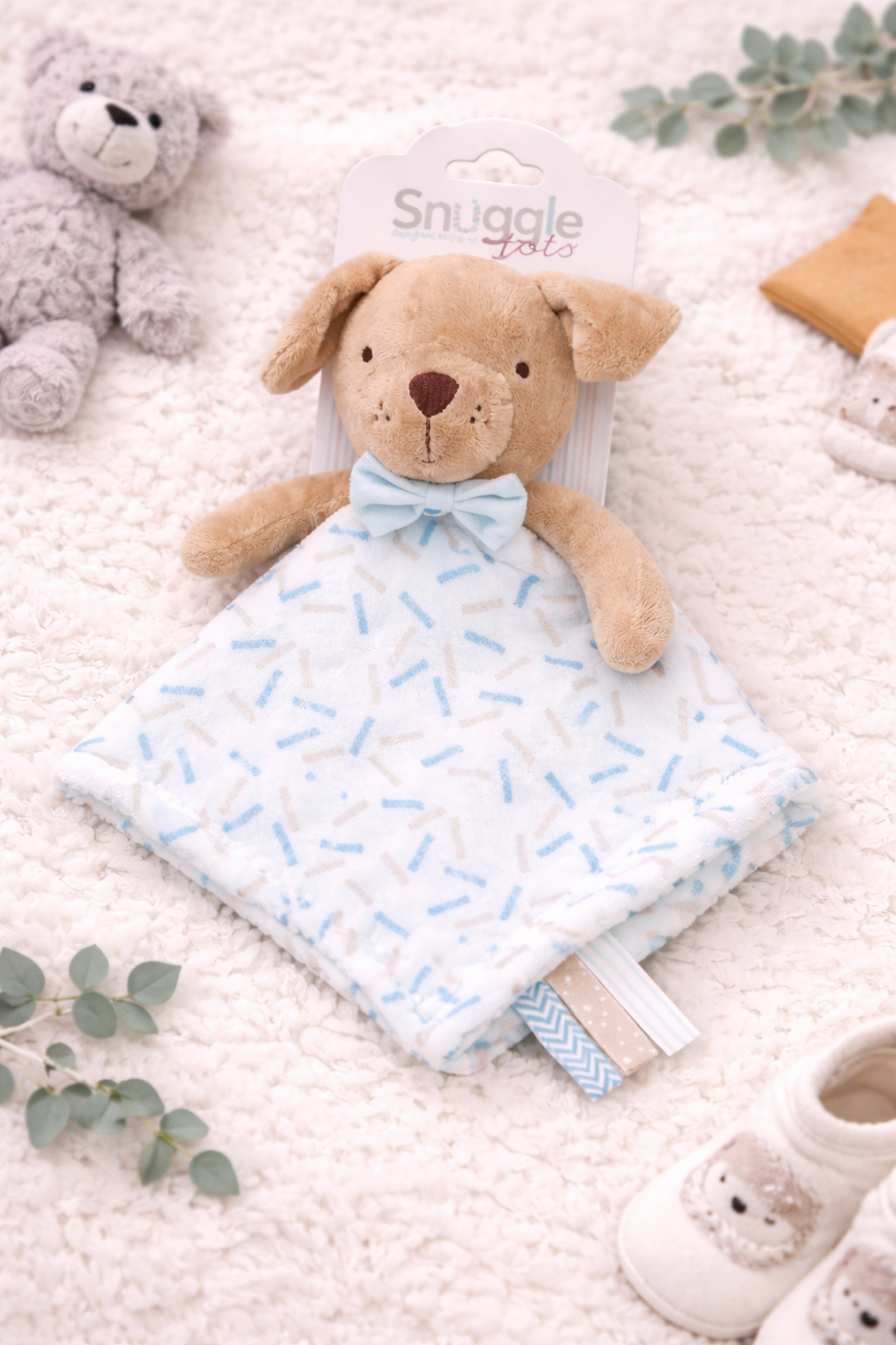Sleeping newborn baby dressed in a soft blue outfit, gently cuddling a plush puppy comforter on a cosy cream blanket, creating a calm and comforting nursery scene.