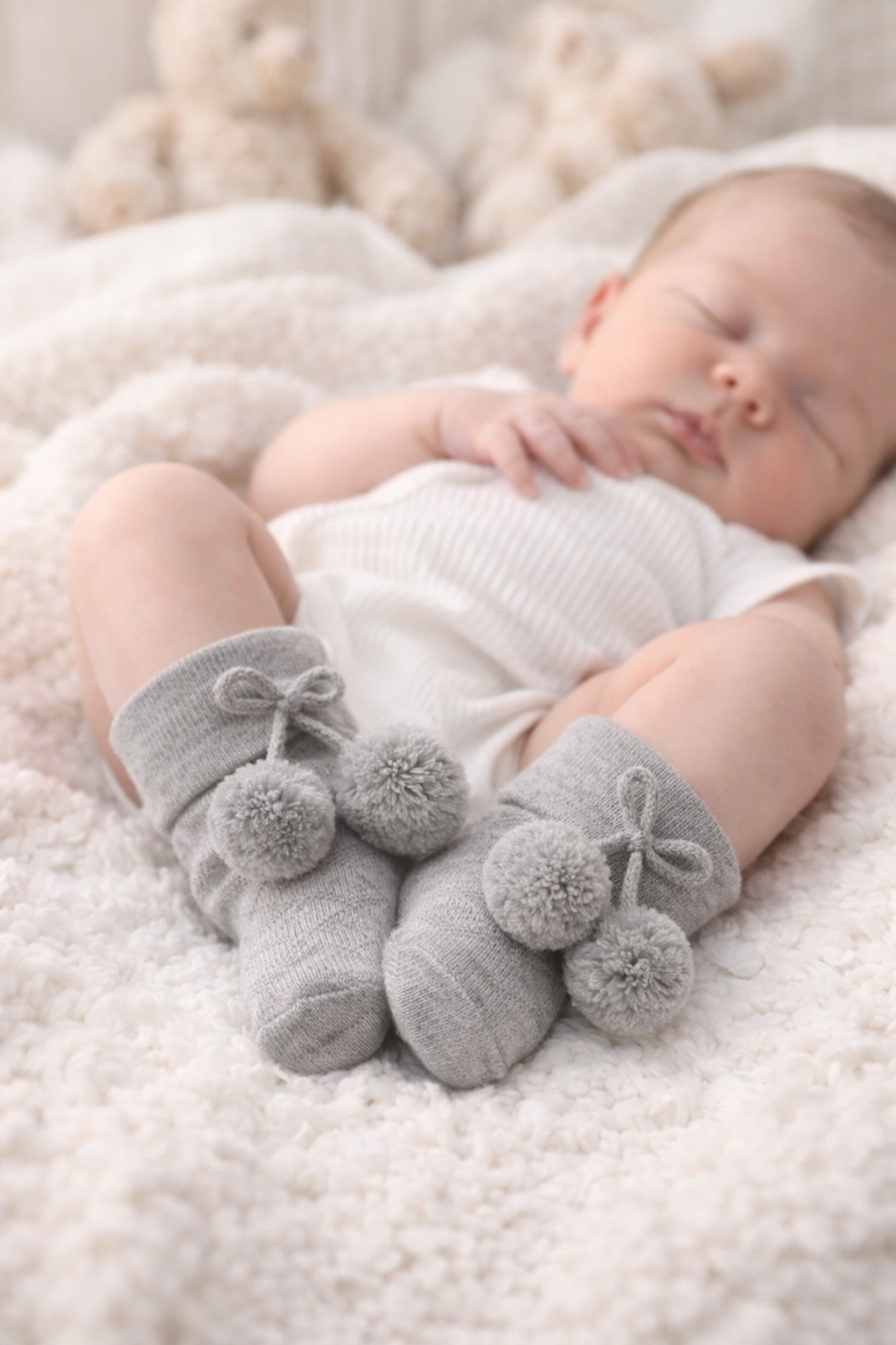 Simple, soft, and beautifully timeless. These newborn grey pom-pom socks are designed to keep tiny feet warm while adding a gentle, stylish touch to any outfit.