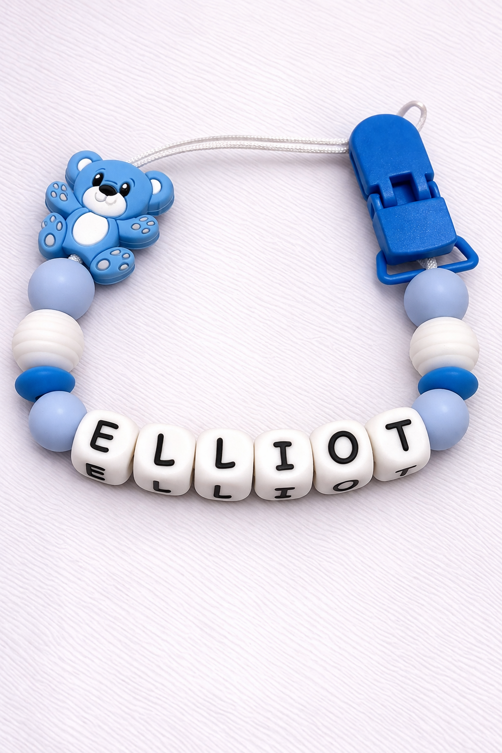 Baby teether with name 'ELLiot' on a white background