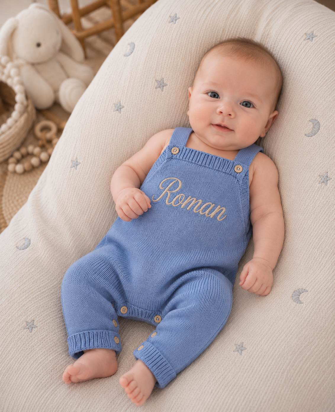 Personalised blue knitted baby boy dungarees with name Roman embroidered on the front bib