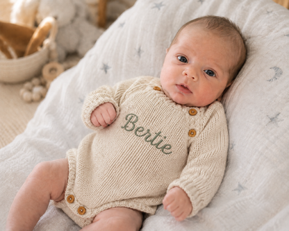 Personalised beige knitted baby romper with name Bertie embroidered on the front