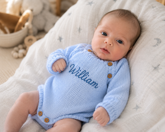 Personalised blue knitted baby romper with name William embroidered on the front