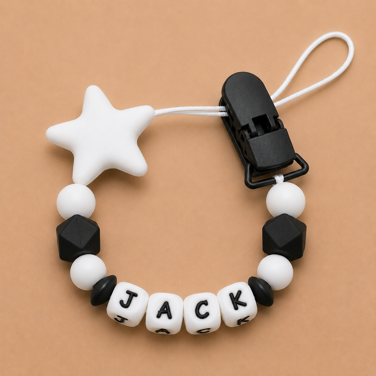 Dummy Clip with star and geometric beads on a beige background