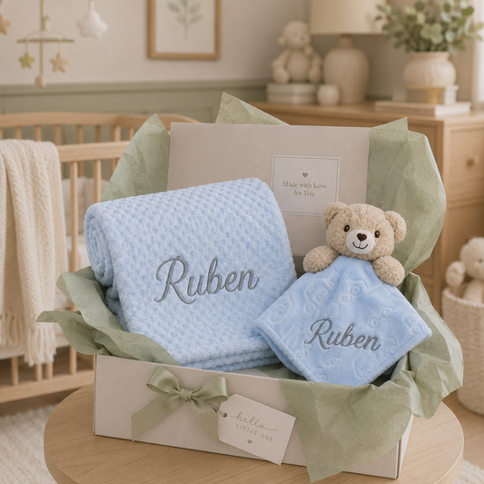 Personalised blue bubble blanket and teddy bear comforter baby gift box with sage green tissue paper and hello little one gift tag.