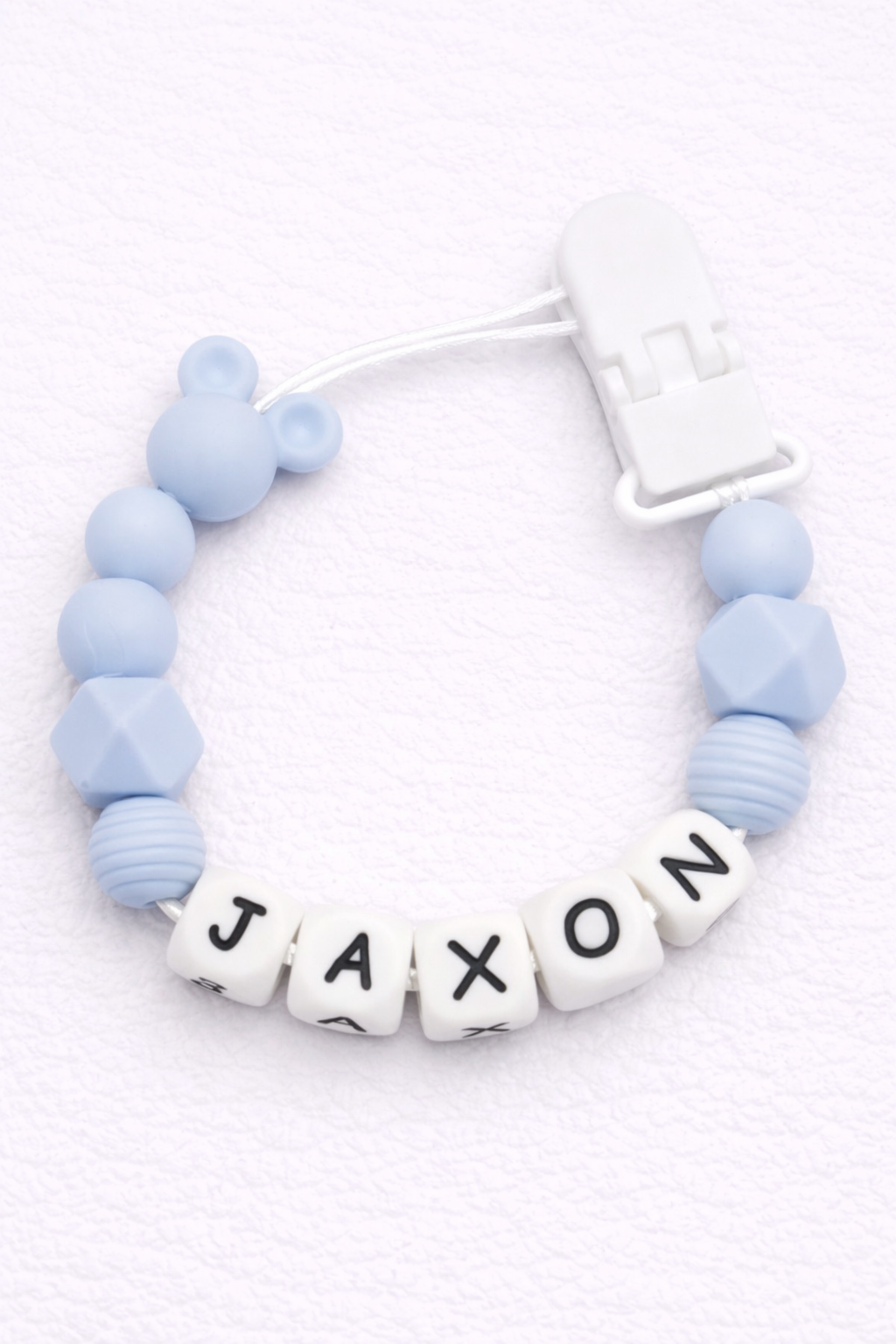 Blue dummy clip with 'JAXON' on a white background