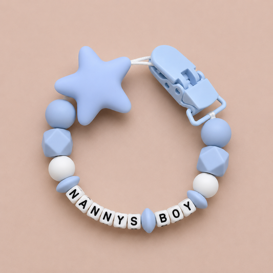 Blue dummy clip with star and geometric beads on a beige background