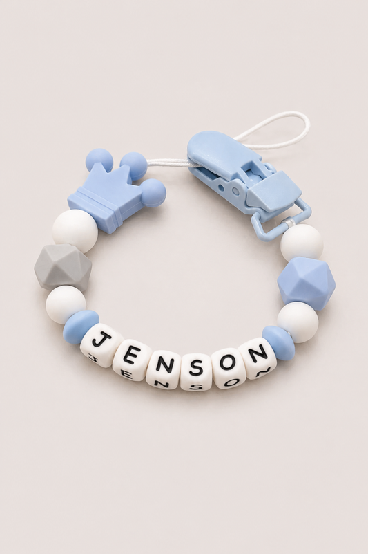 Baby teether with geometric beads and a clip on a light background