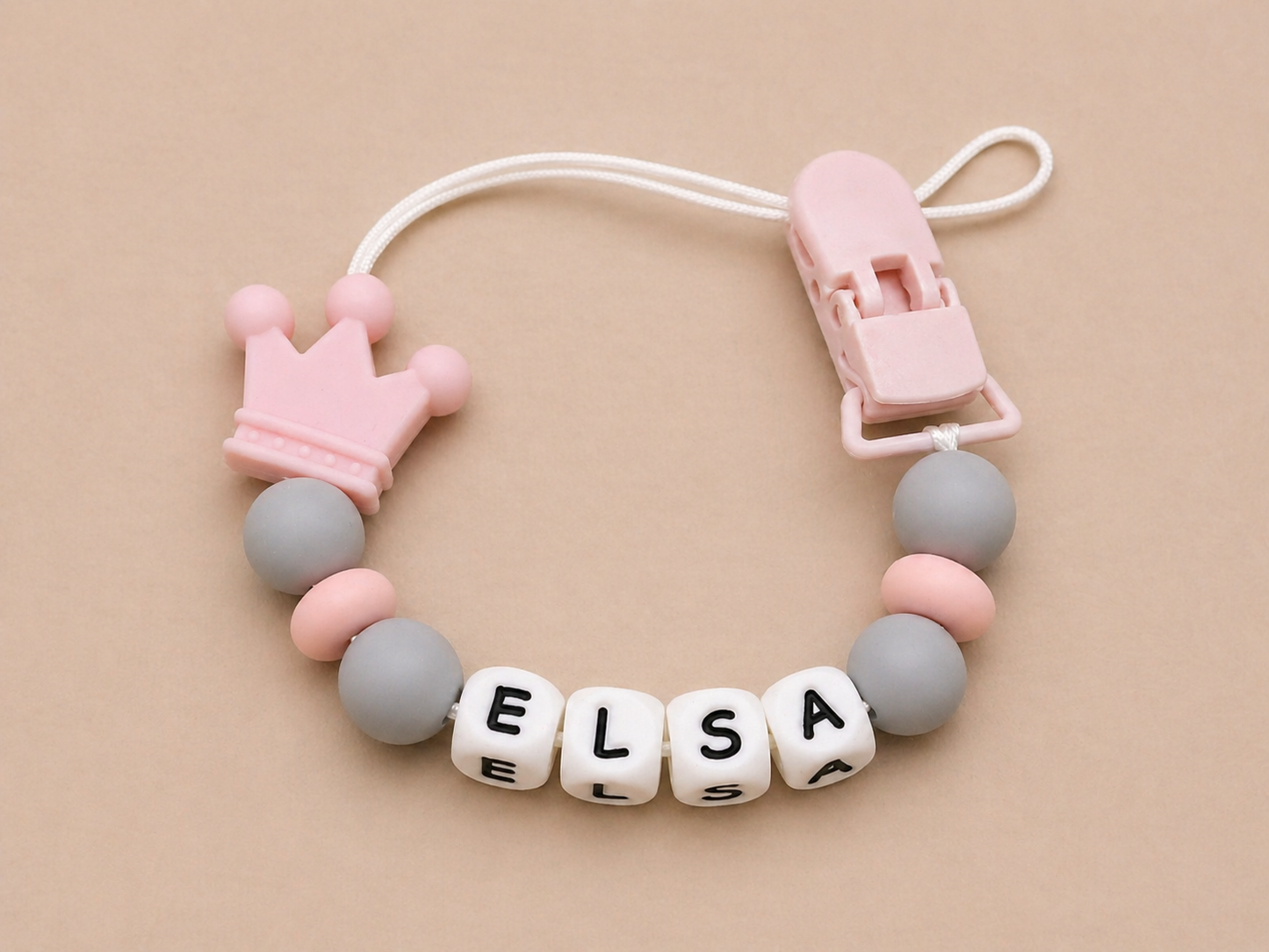 Baby teether with name 'Elsa' on a beige background