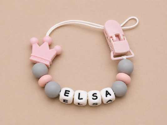 Baby teether with name 'Elsa' on a beige background