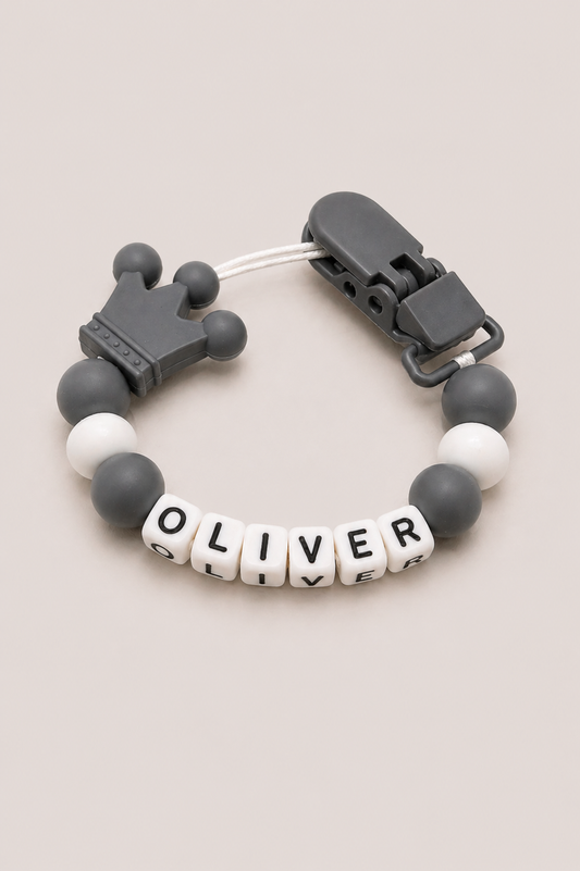 Bracelet with letter beads spelling 'OLIVER' on a beige background