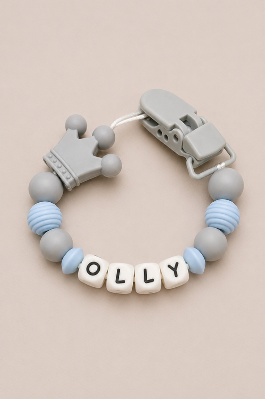 Teething bracelet with 'OLLY' beads on a beige background
