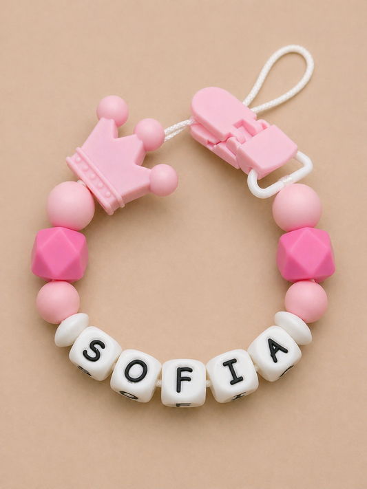 Pink and white teething necklace with 'SOFIA' on a beige background