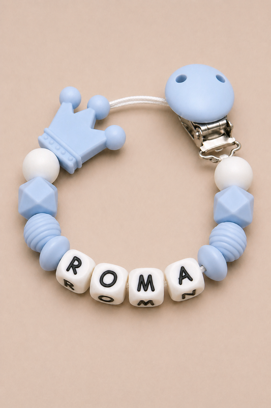 Teething bracelet with blue and white beads and letter cubes on a beige background