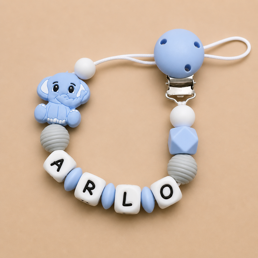 pacifier clip with blue elephant charm and letter beads on a beige background