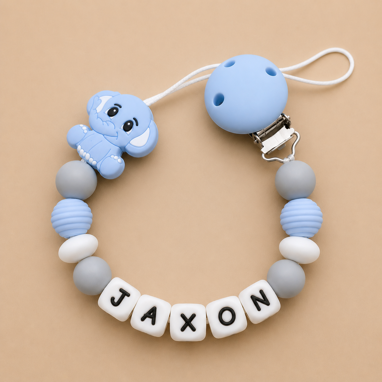 Dummy clip with name 'JAXON' on a beige background