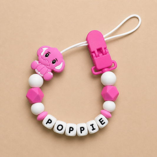 Pink and white dummy clip with 'POPPIE' on a beige background