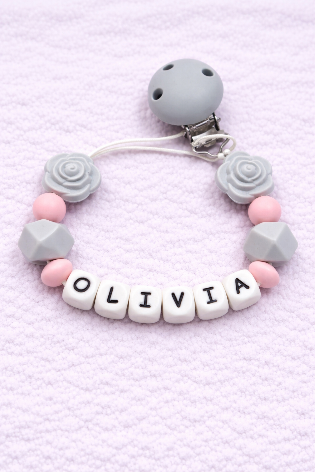 Dummy clip with 'OLIVIA' on a pink textured background