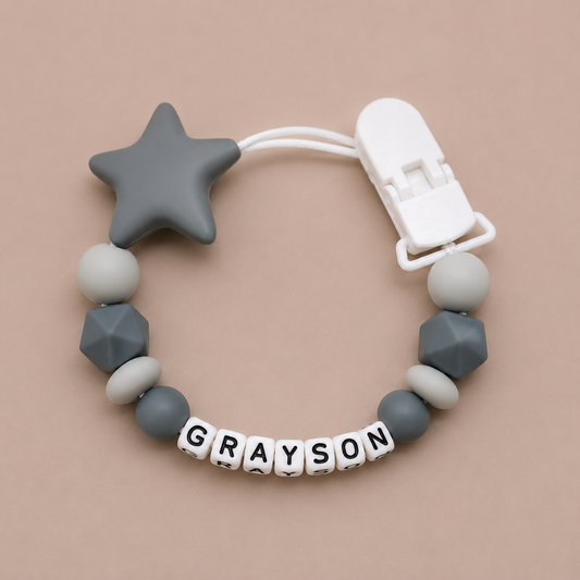 dummy clip with star and geometric beads on a beige background