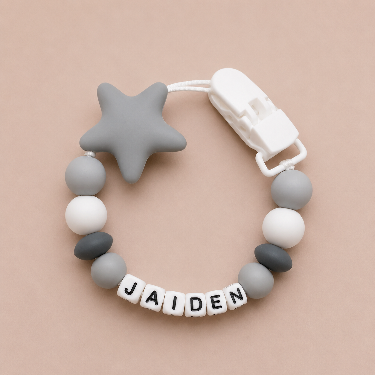 dummy clip with star and beads on a beige background