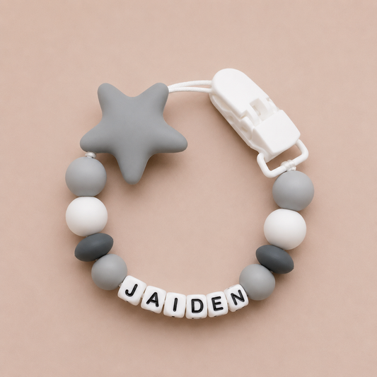 dummy clip with star and beads on a beige background