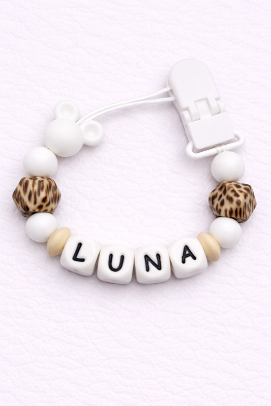 dummy clip with letter beads spelling 'LUNA' on a white background
