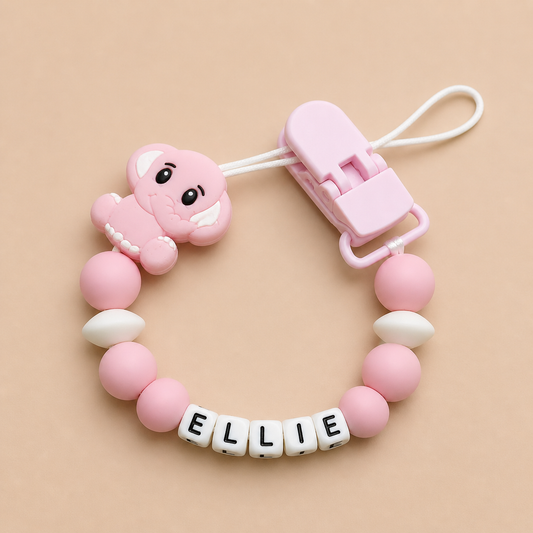 Pink and white dummy clip with a clip on a beige background