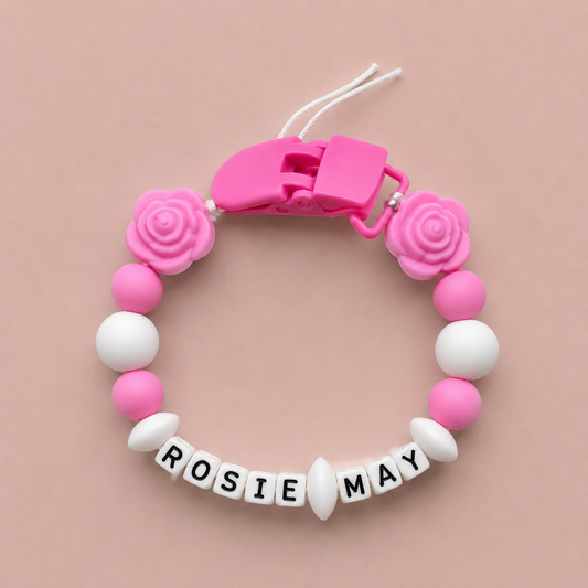 Pink and white Dummy Clip with 'ROSIE MAY' on a pink background
