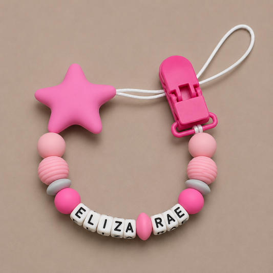 Pink star-shaped dummy clip with a clip and name beads on a beige background
