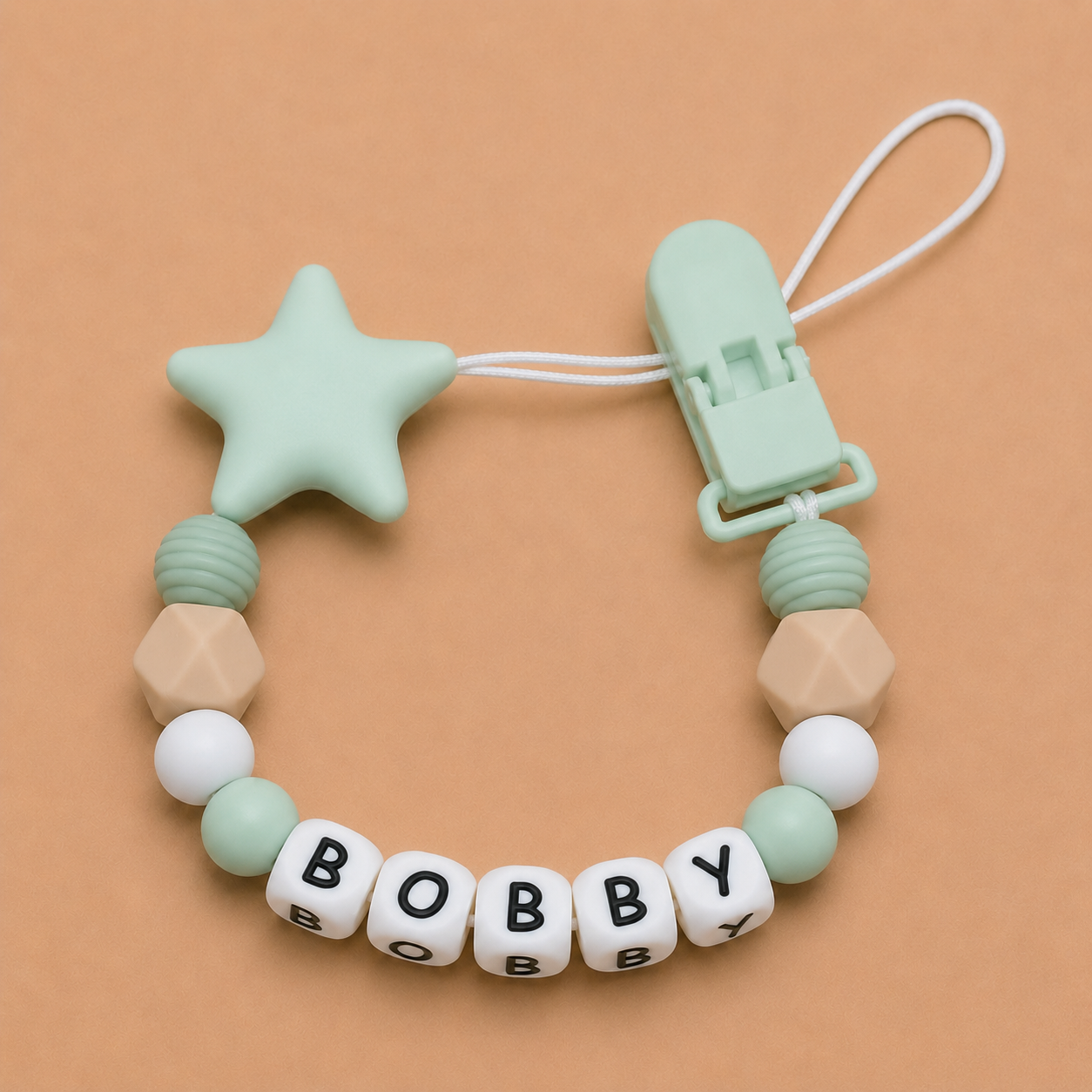 dummy clip with star and geometric beads on a beige background