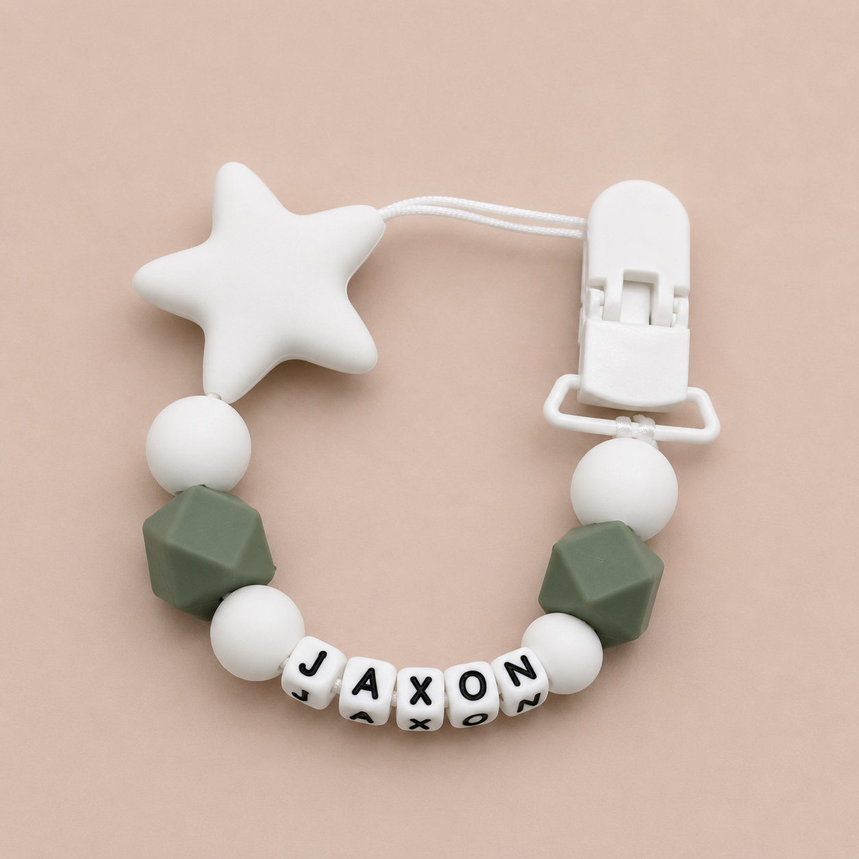 dummy clip with star and geometric beads on a beige background