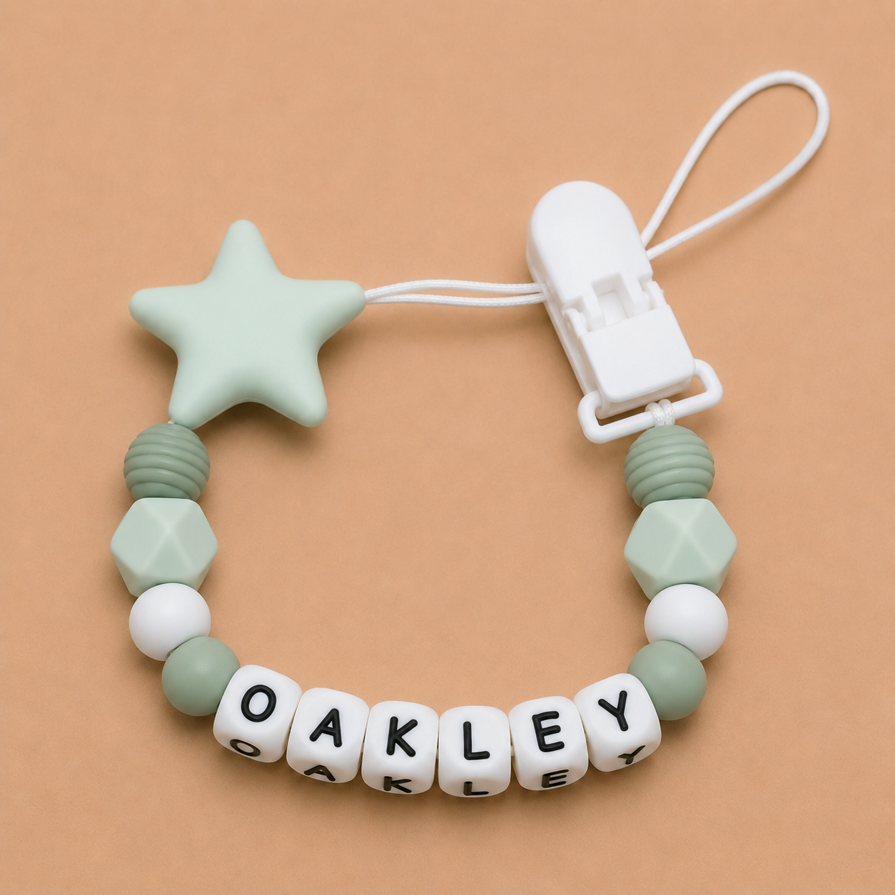 dummy clip with star and geometric beads on a beige background