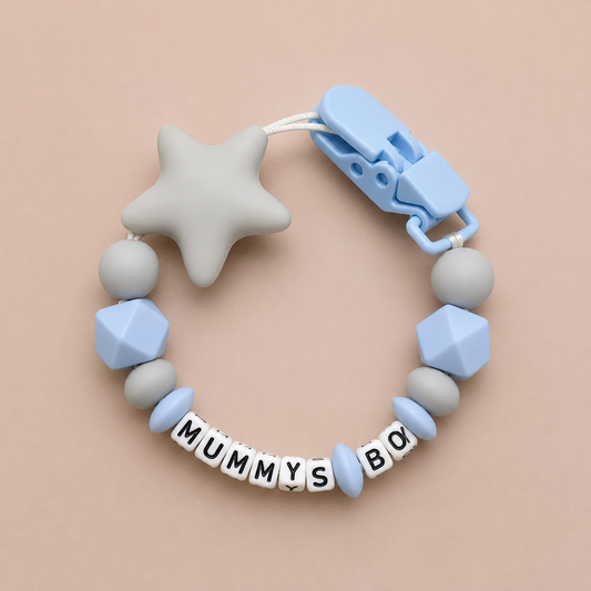Baby dummy clip with geometric beads and star-shaped chewable on a beige background
