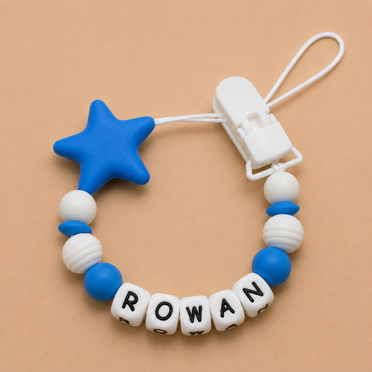 dummy clip with blue star and colored beads spelling 'ROWAN' on a beige background