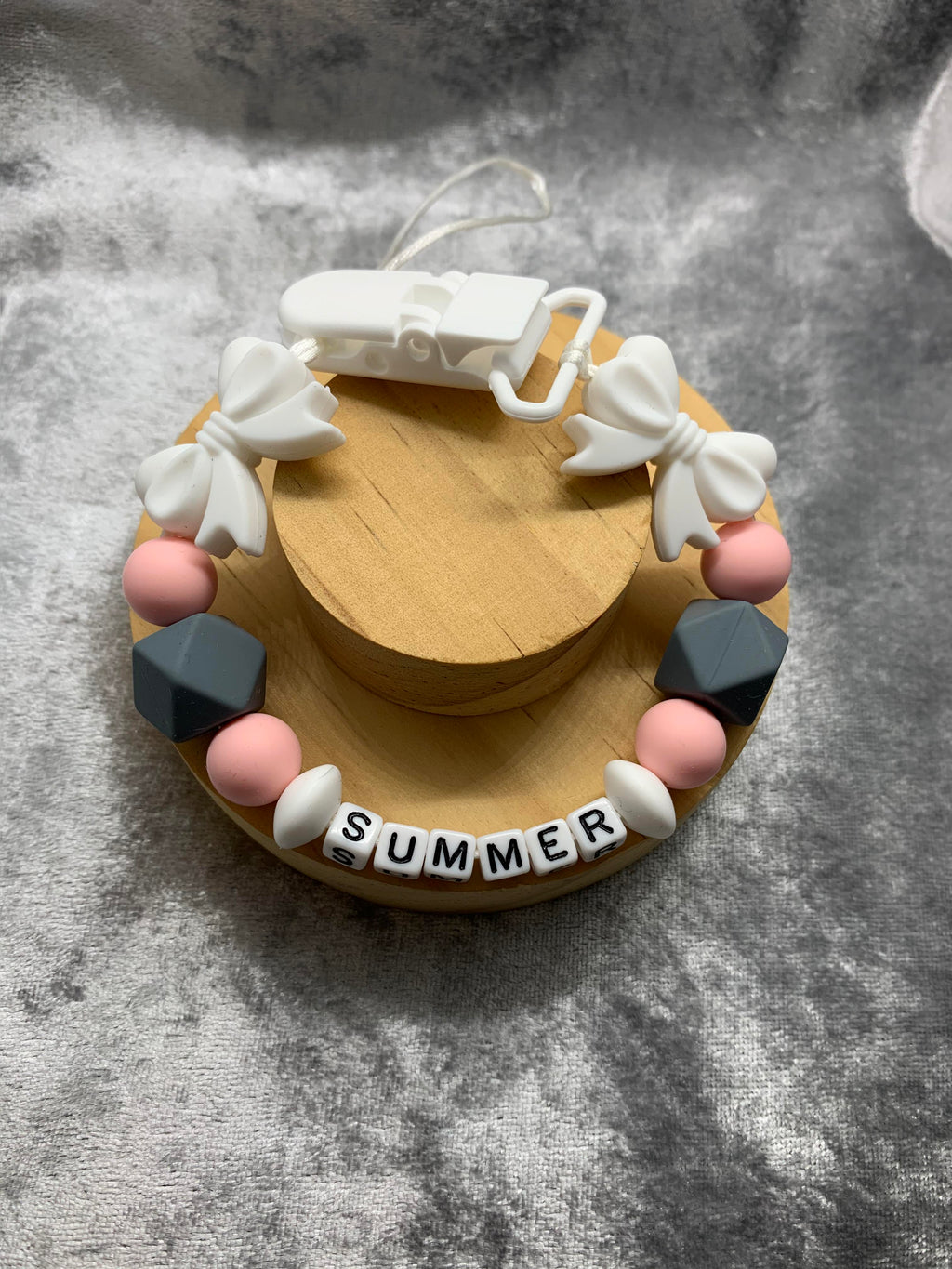 Dummy Chain With 'Summer' Name on a grey textured background. can be personalised with any name.