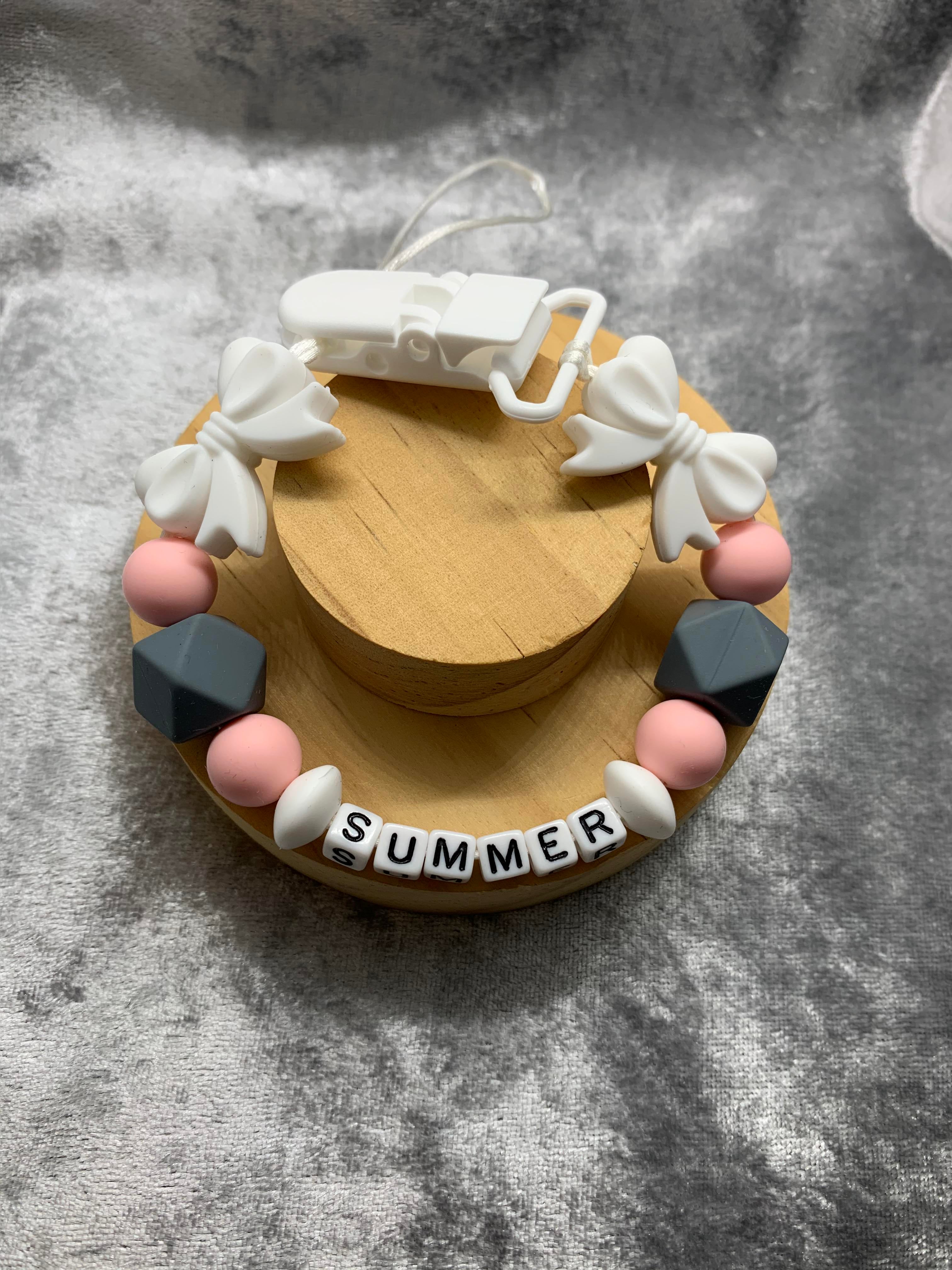 Dummy Chain With 'Summer' Name on a grey textured background. can be personalised with any name.