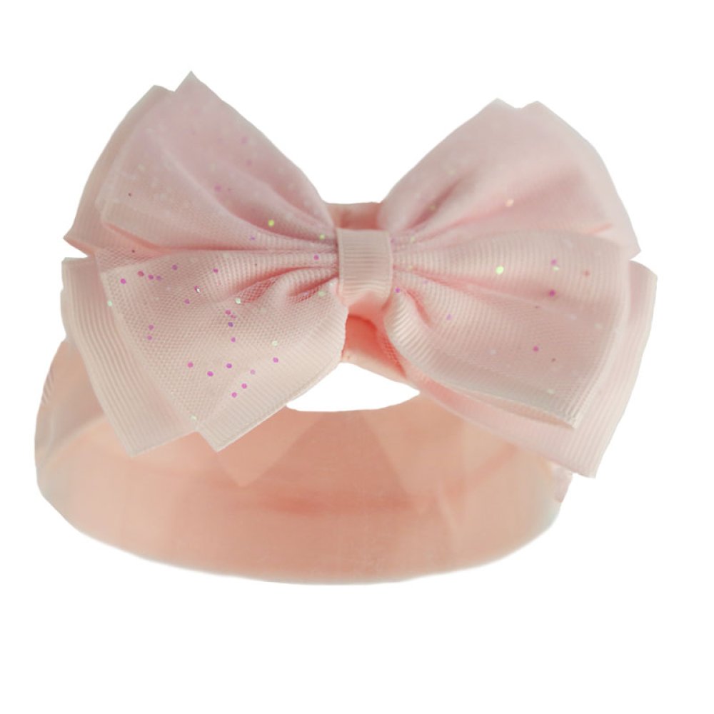 Pink headband with a large bow on a white background