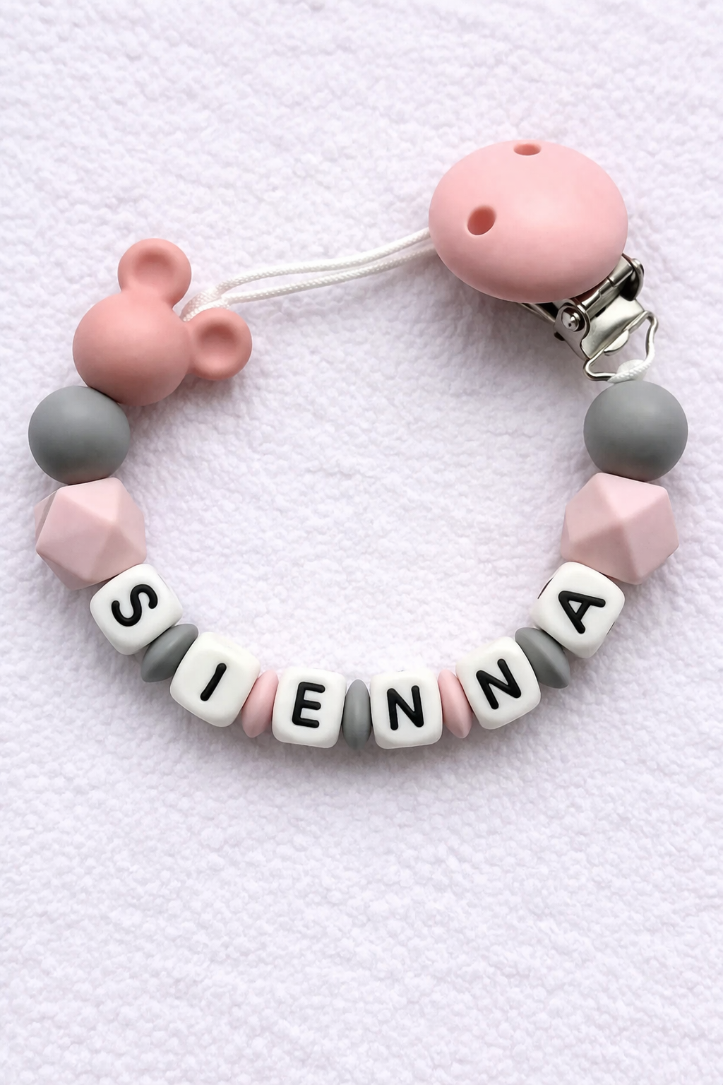 Pacifier clip with colorful beads spelling 'SIEIENNA' on a white background