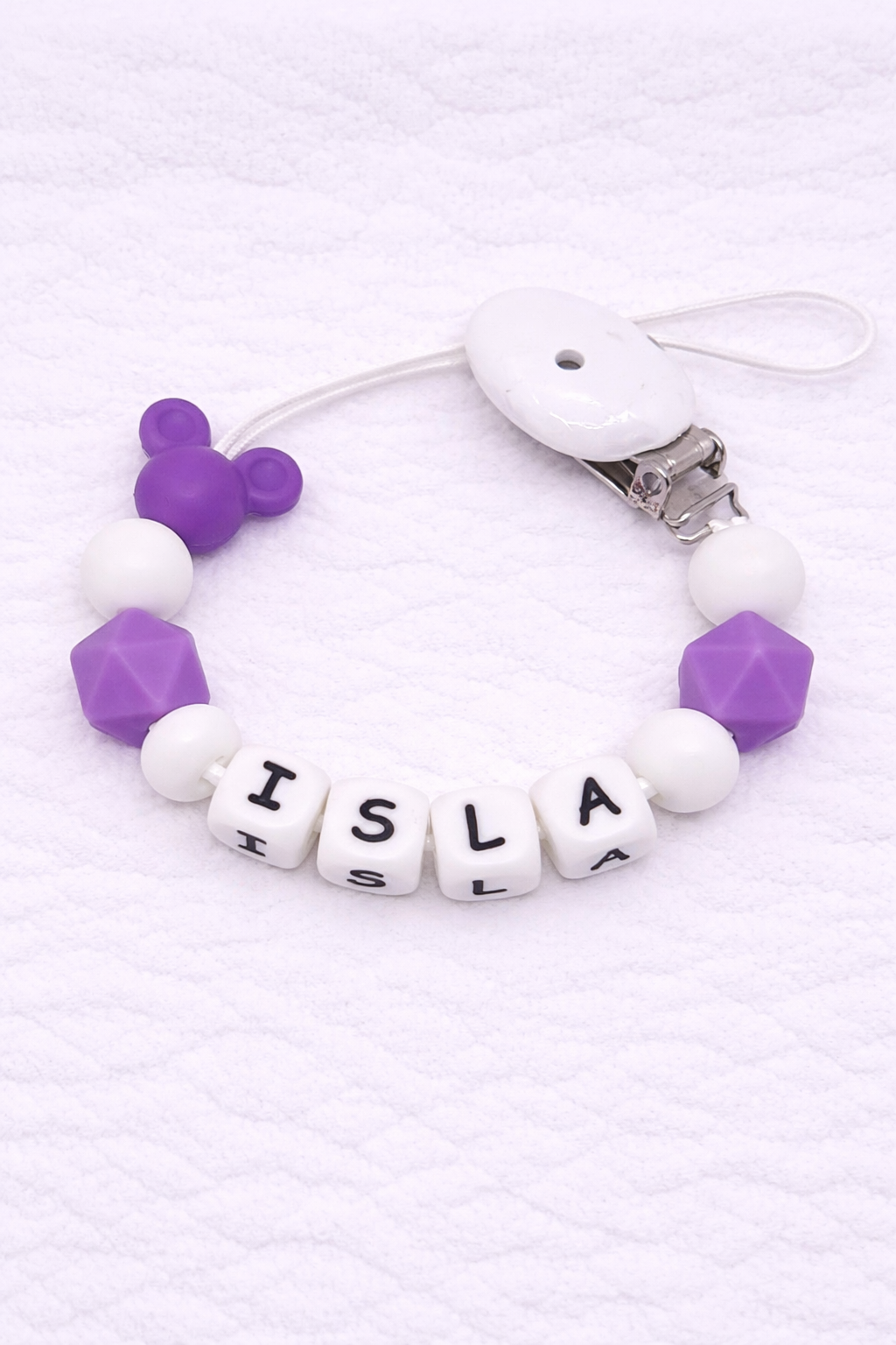 Silicone Dummy Clip with letter beads spelling 'ISLA' on a white background