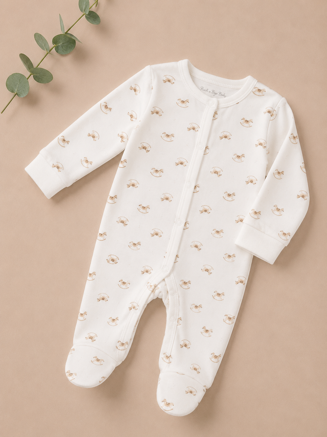 Baby onesie with small patterns on a beige background