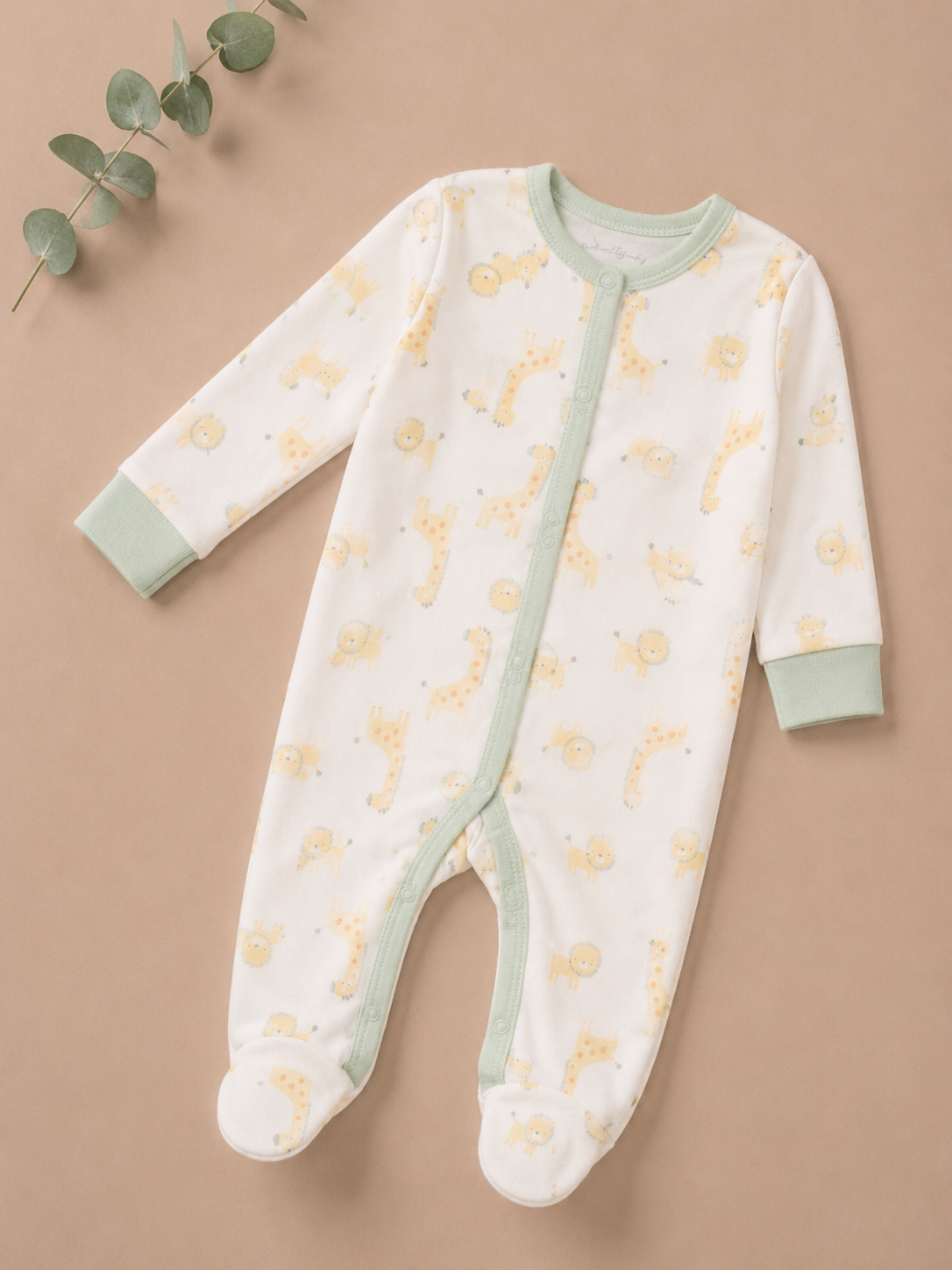 Baby onesie with yellow animal pattern on a beige background