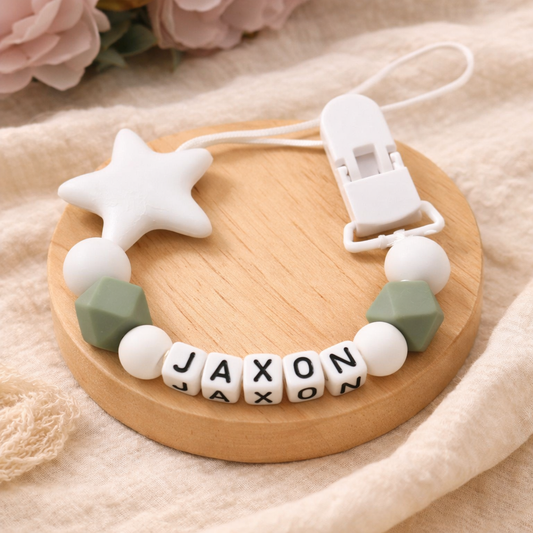 Baby teething necklace with name beads on a wooden tray
