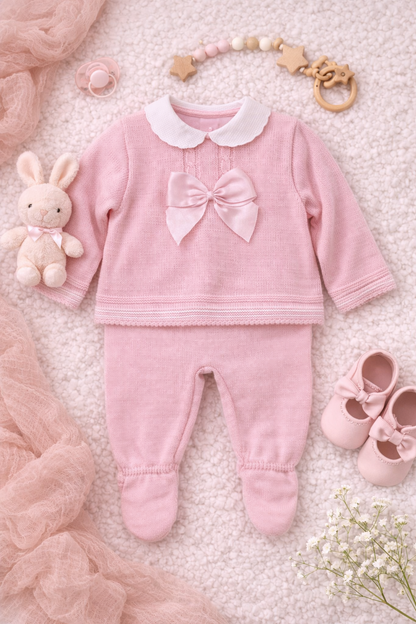 Beautiful Spanish-style knitted baby outfit in pink with white Peter Pan collar and bow detail. Perfect for special occasions and gifts.