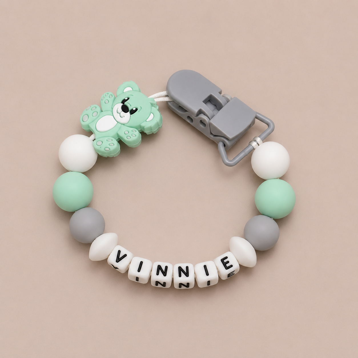 dummy clip with bear clip and 'Vinnie' beads on a beige background