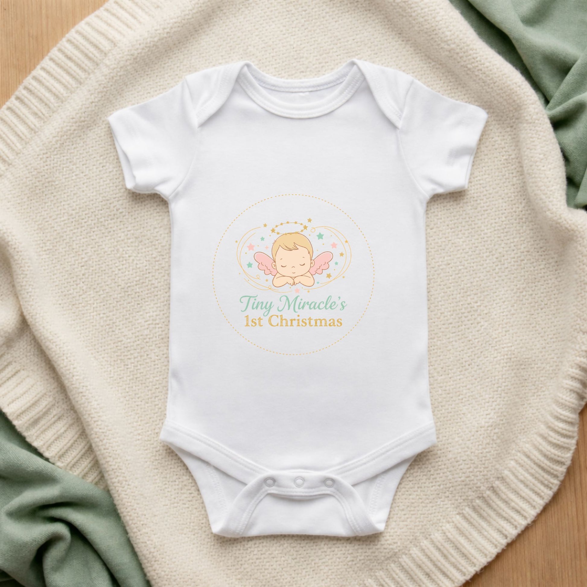 White baby onesie with a design and text on a textured surface Tiny Miracle's 1st Christmas Angel Baby Bodysuit