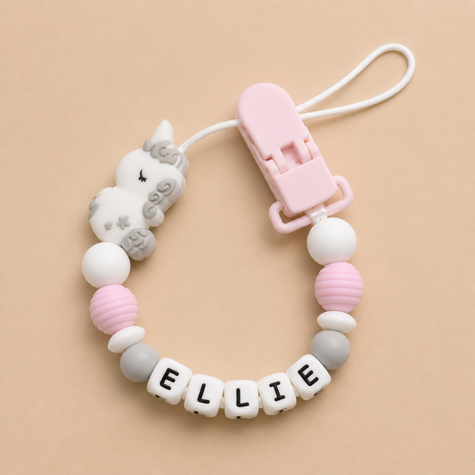 Baby dummy clip with name 'ELLIE' on a beige background