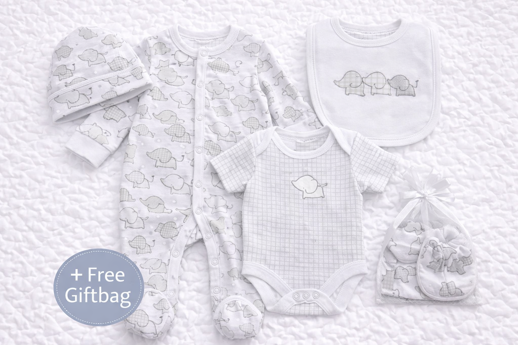 Unisex newborn baby gift set featuring a soft cotton elephant-print sleepsuit, short-sleeve bodysuit, matching bib, hat and scratch mittens in neutral white and grey tones, ideal for baby showers and newborn gifts.