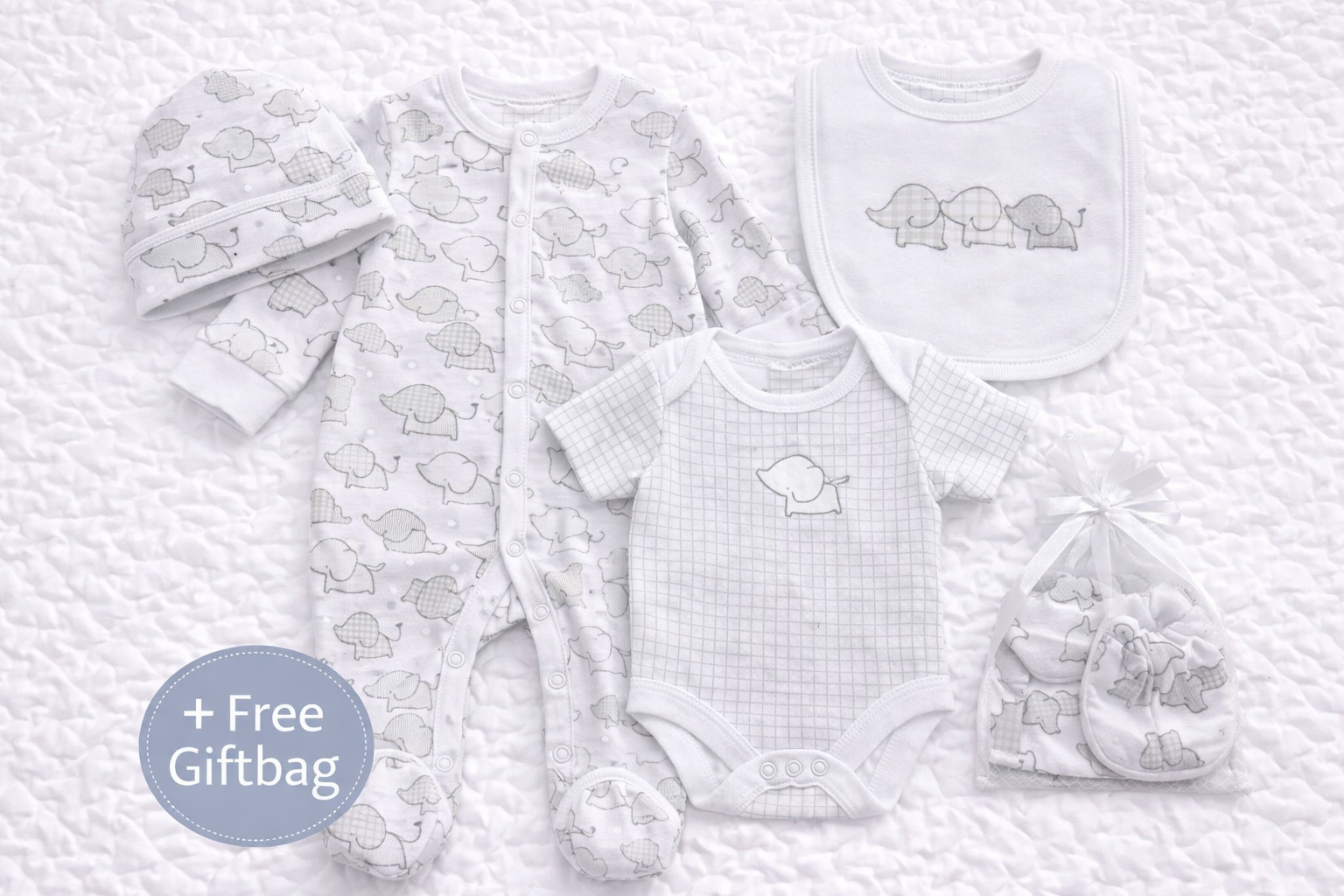 Unisex newborn baby gift set featuring a soft cotton elephant-print sleepsuit, short-sleeve bodysuit, matching bib, hat and scratch mittens in neutral white and grey tones, ideal for baby showers and newborn gifts.