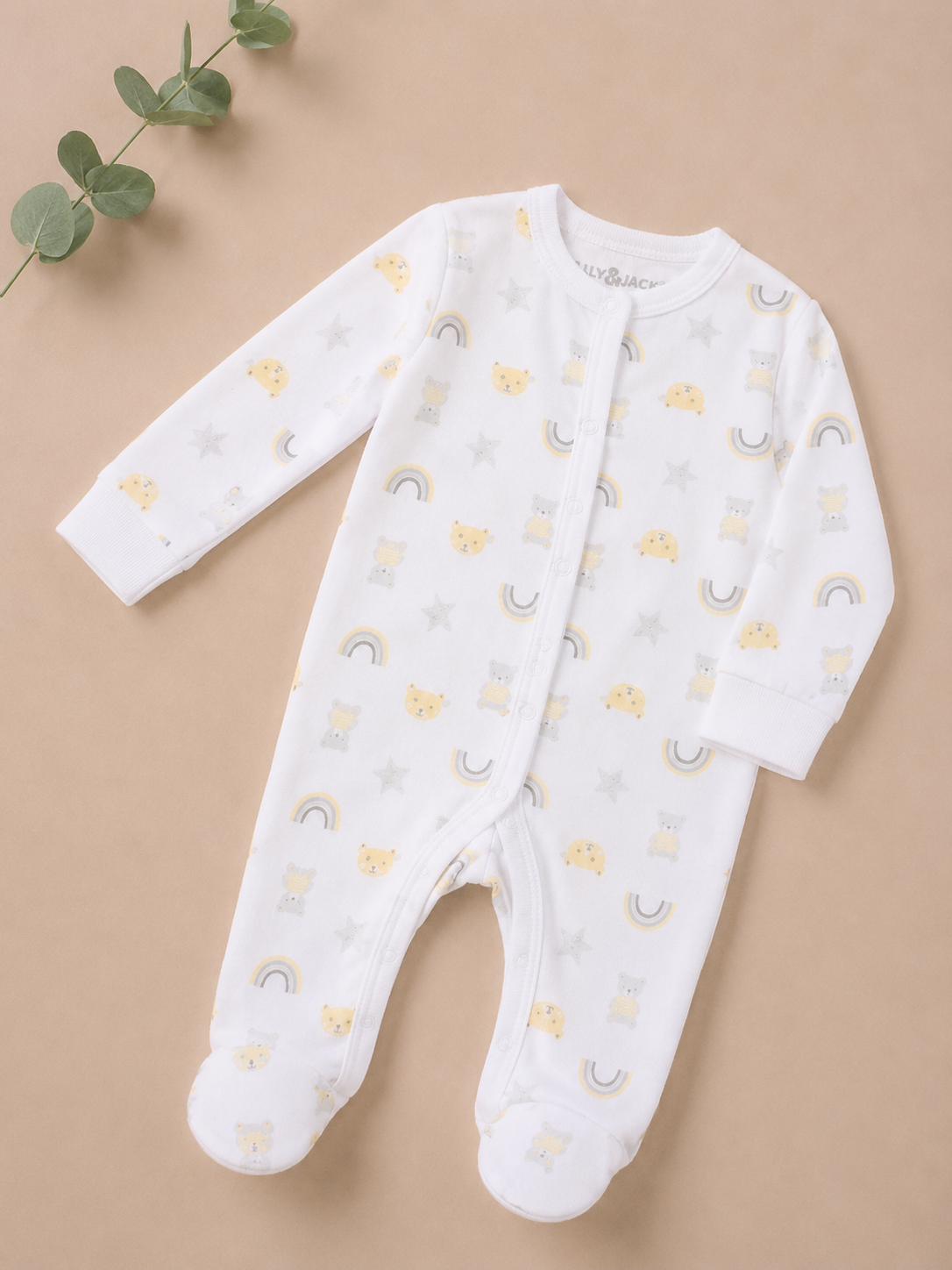 Baby onesie with cloud and rainbow pattern on a beige background