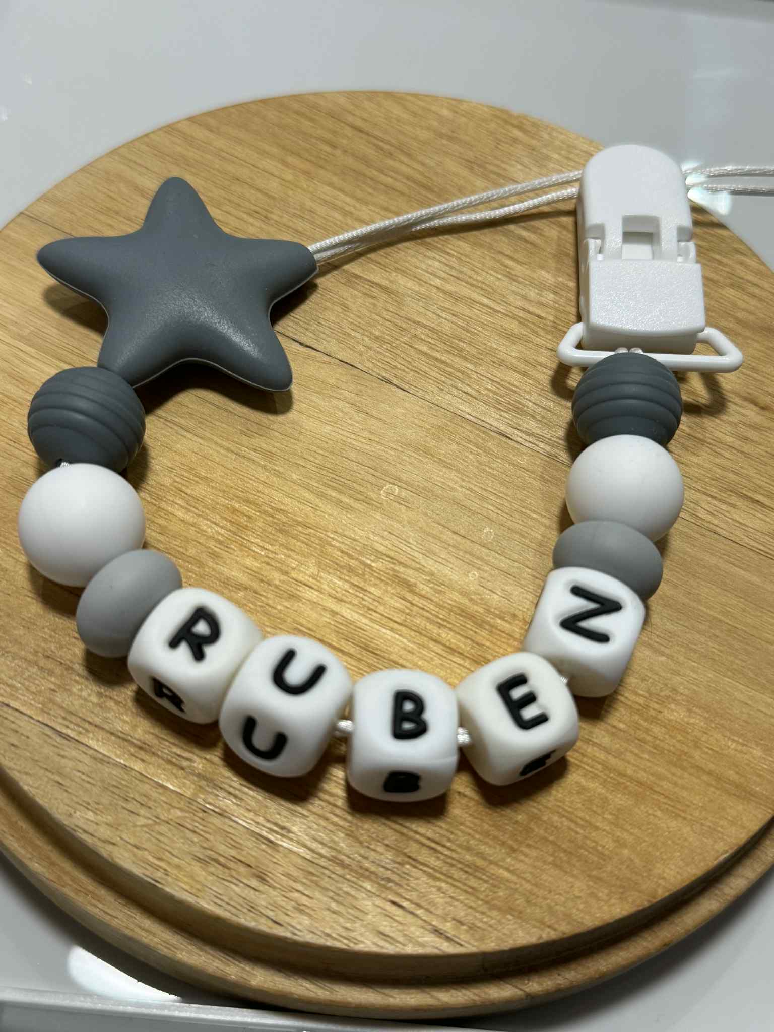 A dummy clip in Grey and white colors, personalized with any name 